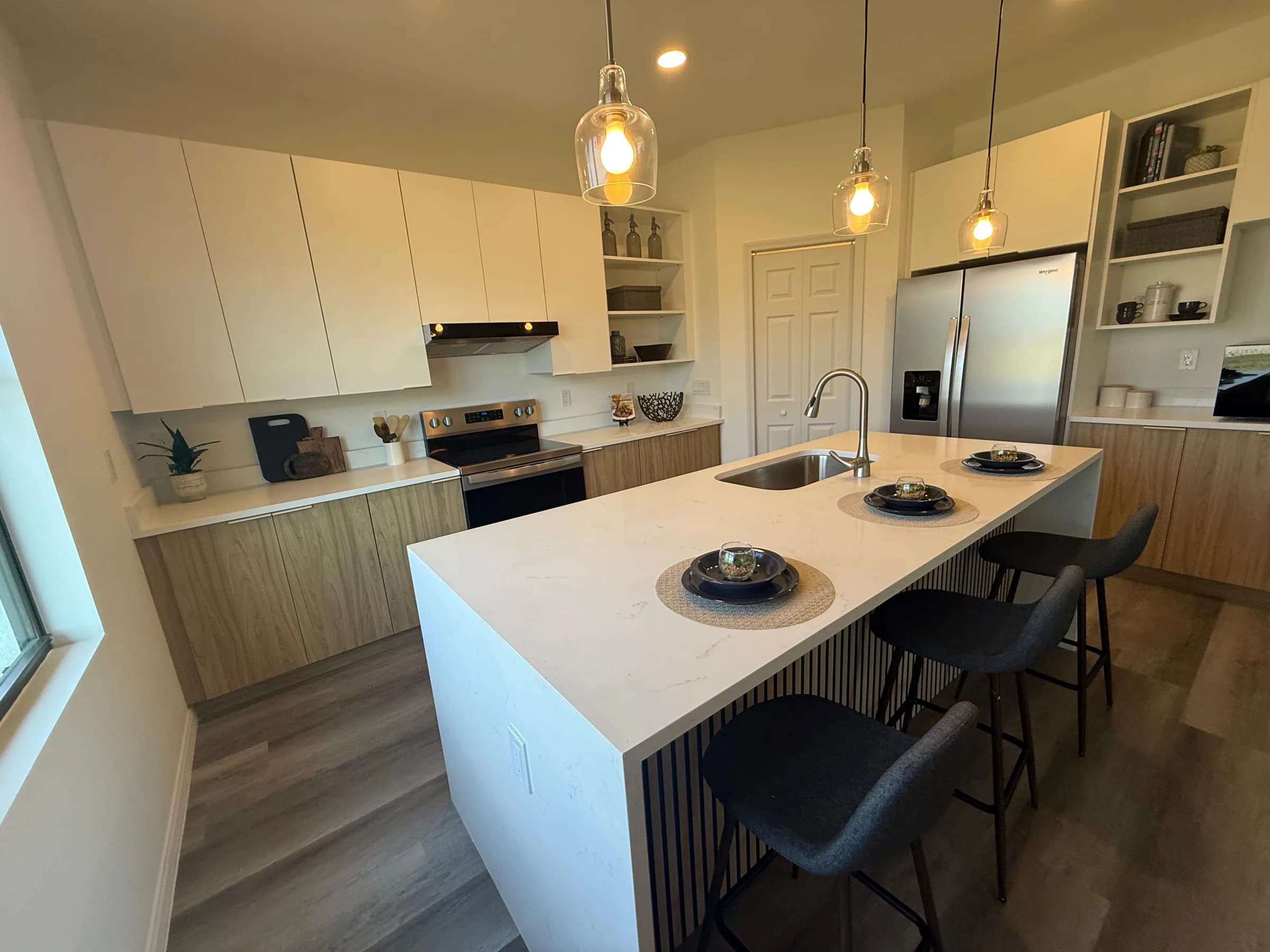 Completed custom kitchen with a large island and pendant lighting