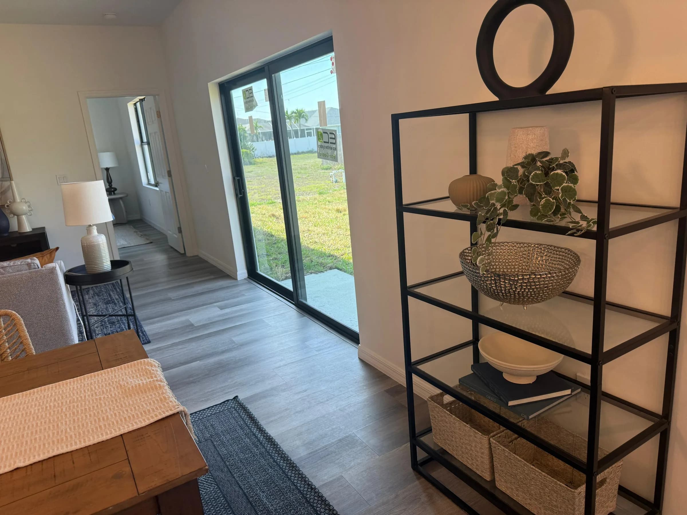 Living and dining area with shelving and sliding glass doors